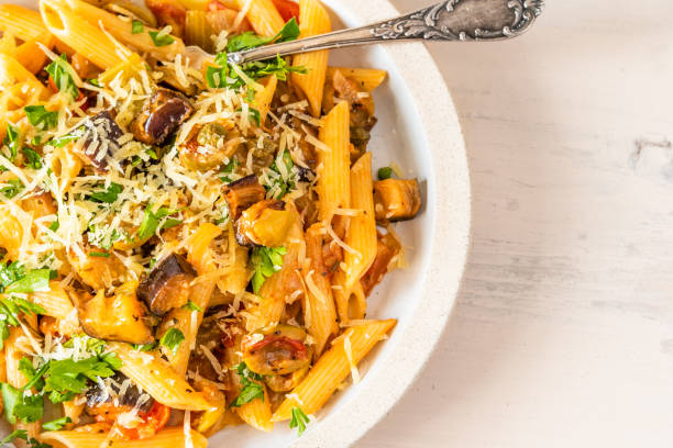 istock Pasta caponata on a plate on a light rustic table. Recipe copy space 1070883180