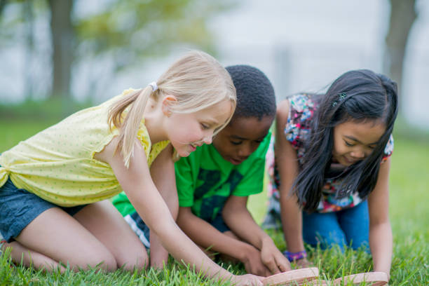istock Children examining the grass with magnifying glasses 1070887910