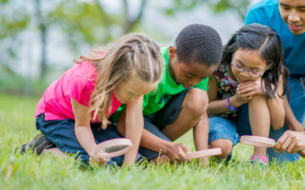 istock Children examining the grass with magnifying glasses 1070887912