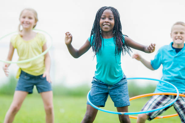istock Children with hula hoops in a park 1070887922