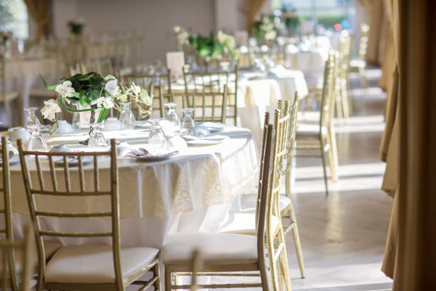 istock table sets in wedding hall. wedding decorate preparation. table set and another catered event dinner, 1070888066