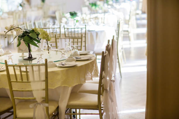 istock table sets in wedding hall. wedding decorate preparation. table set and another catered event dinner, 1070888068