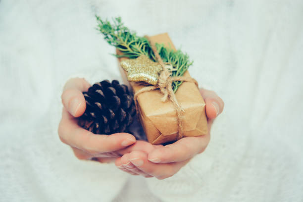istock Woman's hands hold christmas or new year gift box. 1070889336