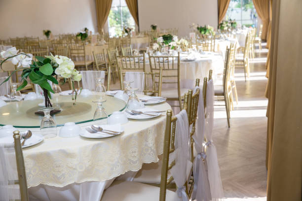 istock table sets in wedding hall. wedding decorate preparation. table set and another catered event dinner, 1070889346