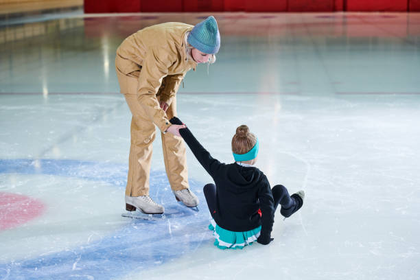 istock Girl Falling in Ice-Skating 1070889542