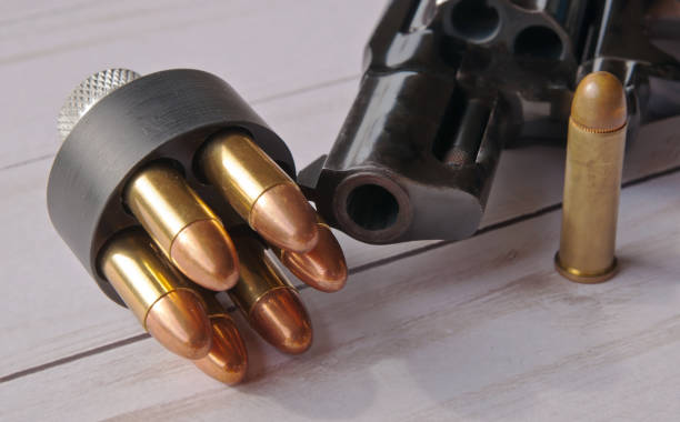 istock A loaded speed loader loaded with 38 special full metal jacket bullets in front of a black revolver 1070891704