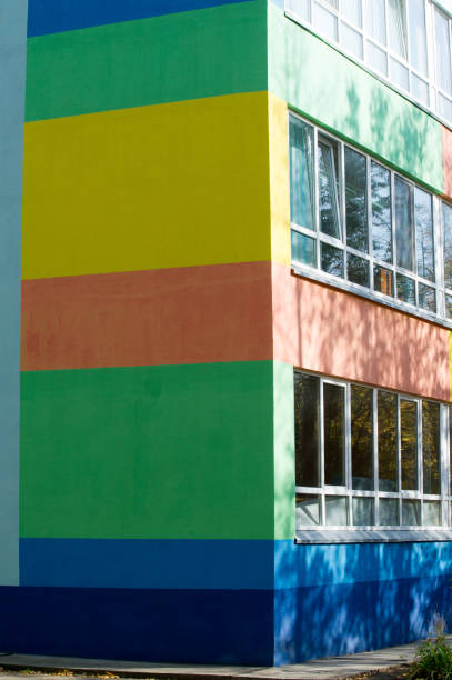 istock Texture, background, pattern. The wall of the building is painted with bright colors, a game of shadows from trees 1070896456