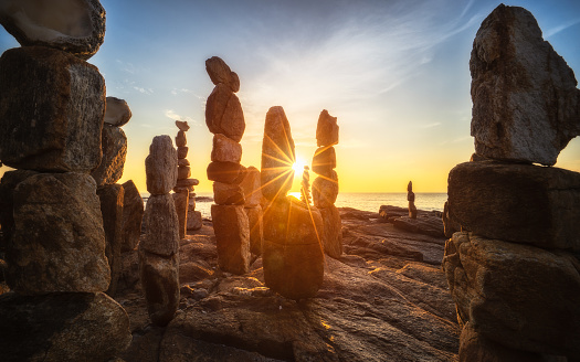 Stones towers on the Samed Island in Thailand with sunrise on the beach.