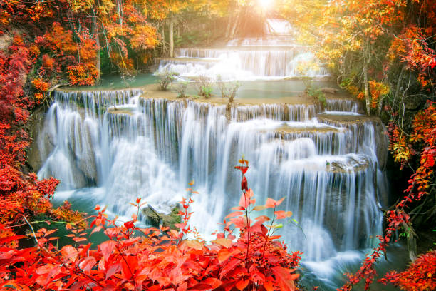 istock Amazing waterfall in autumn forest 1070904008