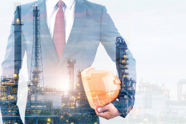 istock double exposure of engineer or worker hold in hand yellow helmet for workers security with blur oil and gas refinery plant background 1070905926