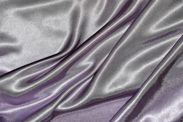 istock Beautiful smooth elegant wavy violet purple satin silk luxury cloth fabric texture, abstract background design. Card or banner. 1070906770