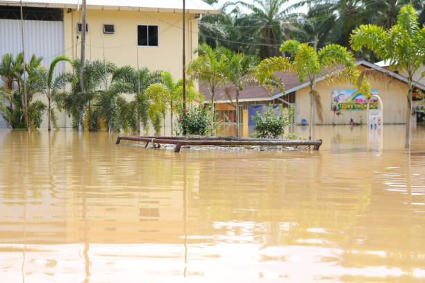 Natural disaster of overflooding in village of Panchor, Malaysia MALAYSIA, MUAR, PANCHOR - FEBRUARY 2011: Natural disaster of flooding takes place in Panchor in 2011. Houses, schools and facilities are submerged in water. johor photos stock pictures, royalty-free photos & images