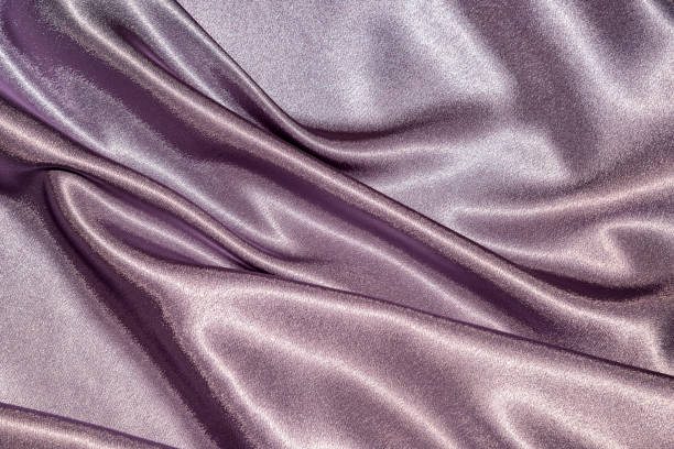istock Beautiful smooth elegant wavy violet purple satin silk luxury cloth fabric texture, abstract background design. Card or banner. 1070910492