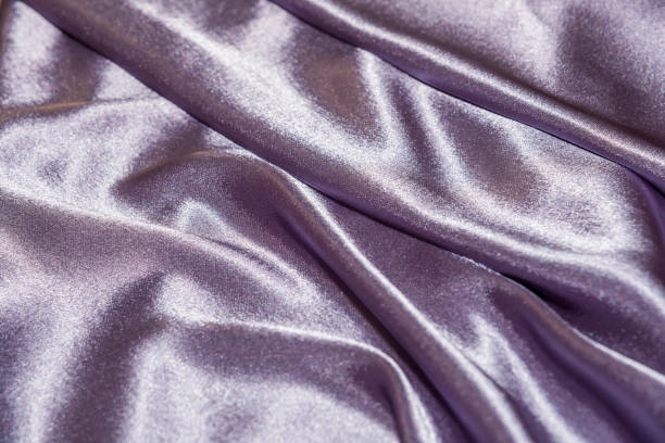 istock Beautiful smooth elegant wavy violet purple satin silk luxury cloth fabric texture, abstract background design. Card or banner. 1070912472