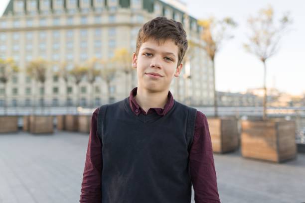 outdoor portrait of smiling teenager boy 14, 15 years old. city background, golden hour. - teenager 14 15 years 13 14 years cheerful imagens e fotografias de stock