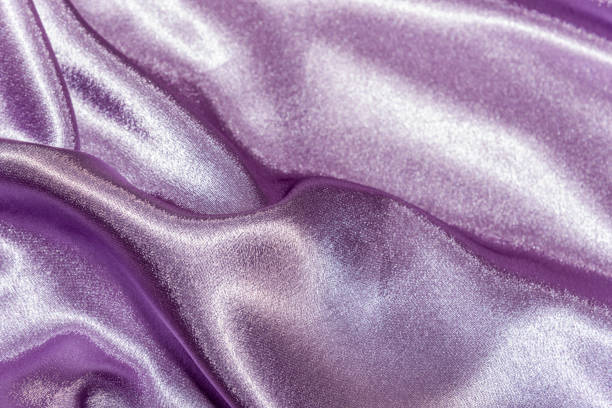 istock Beautiful smooth elegant wavy violet purple satin silk luxury cloth fabric texture, abstract background design. Card or banner. 1070921206