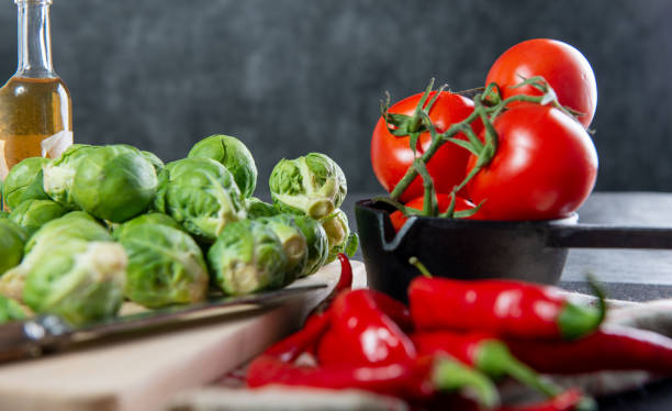 The composition highlights the texture and color of the basil against the other raw produce. ideal for culinary blogs, menus, and cooking class promotion