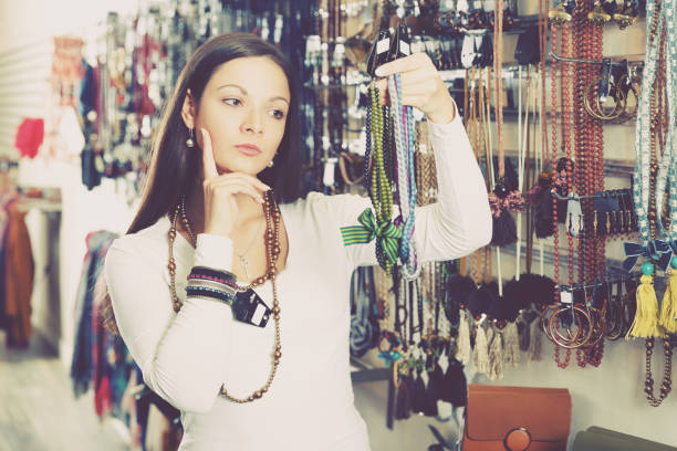 istock girl selecting  bracelets and pendants 1070928454