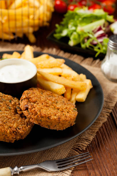 istock Serving of falafel and chips served on a black plate with sauce. 1070930832