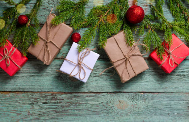 istock Christmas composition with presents and fir branches on rustic turquoise wooden board. 1070932064
