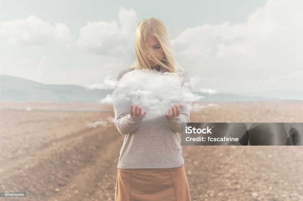 surreal moment , woman holding in her hands a soft cloud Fog Stock Photo