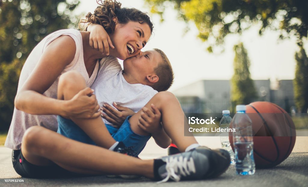 The most valuable kiss in the world. The most valuable kiss in the world. Mother and son on playground. Close up. Family Stock Photo