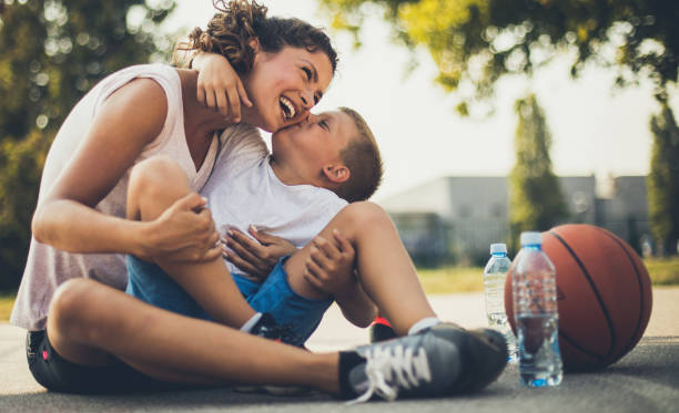 The most valuable kiss in the world. The most valuable kiss in the world. Mother and son on playground. Close up. single mother photos stock pictures, royalty-free photos & images