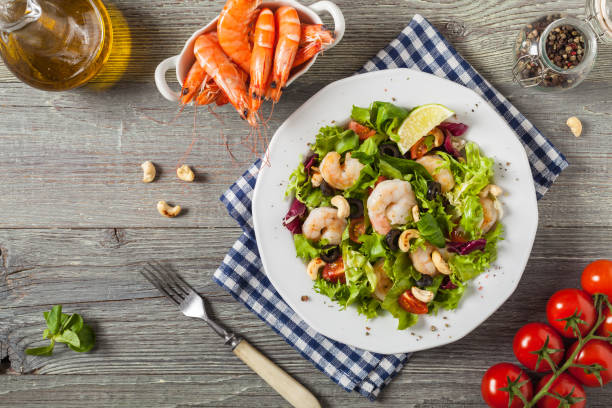 istock Shrimp salad with tomato, olives and cashew nuts. 1070938376
