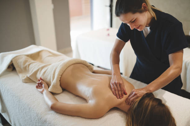 istock Masseur massaging back of female 1070941356