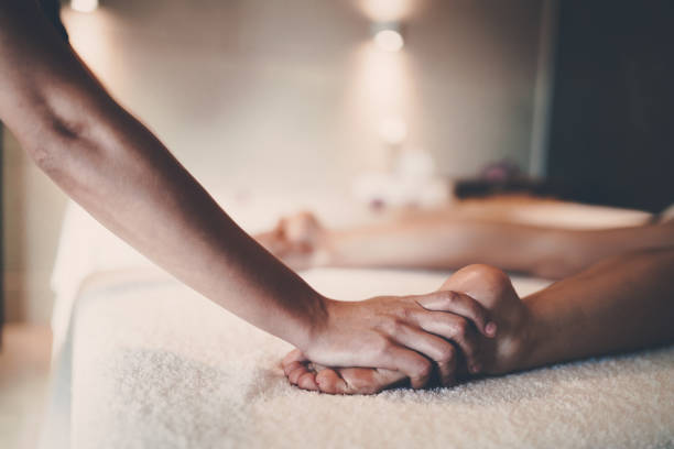 istock Masseur massaging masseuse during therapeutic tretment 1070941400