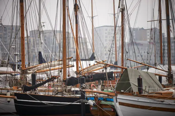 different sail wooden sail boats in a harbor