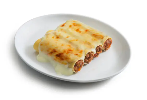plate of cannelloni with meat sauce, typical italian food dish