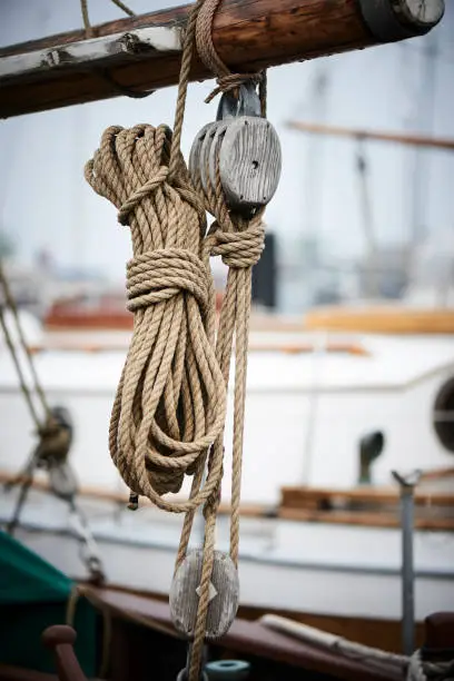 different sail wooden sail boats in a harbor