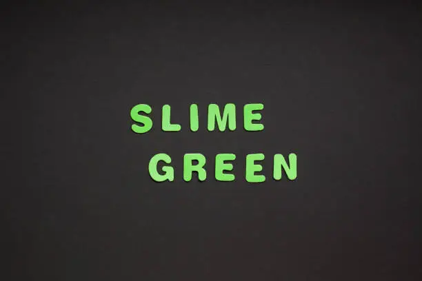 Photo of Slime green writing on black paper background