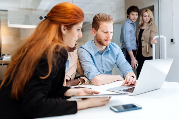 istock Business people collaborating in office and working on project together 1070943846