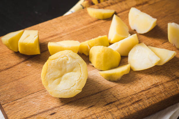 istock Cooked potato on a cutting board for slicing 1070944062