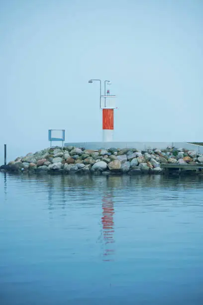 Boat entering the harbor on a quiet morning at the sea