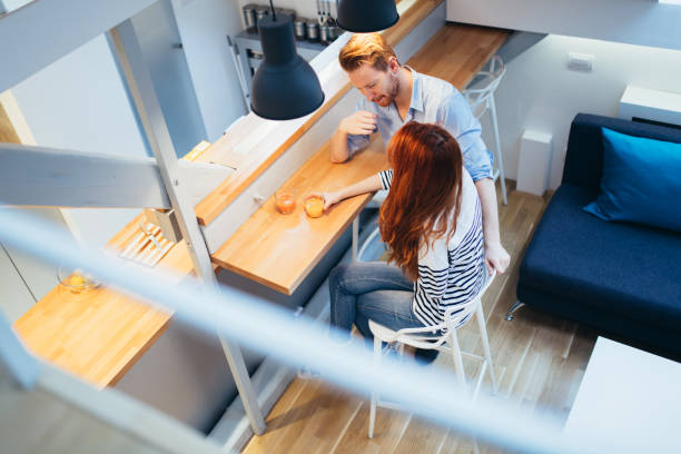 istock Couple drinking juice in beautiful kitchen 1070945998