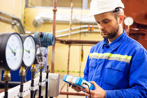 Mechanical engineer measuring values of pressure on manometers stock photo