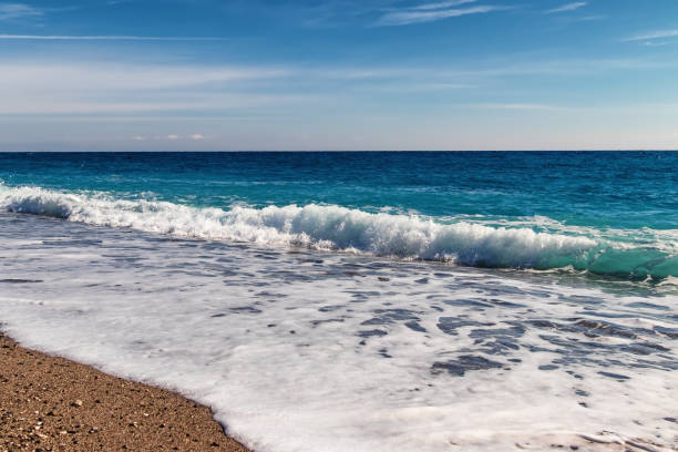 istock waves of the Mediterranean sea roll on the pebble beach 1070949810