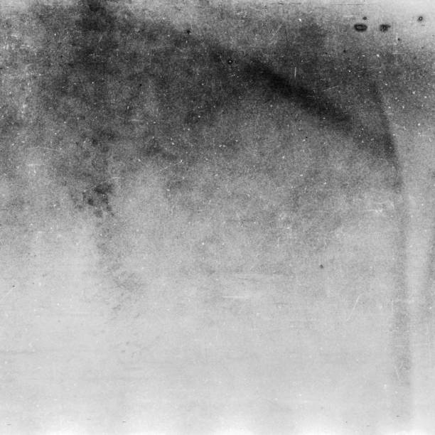 istock Black and white textured background with light leaks and grain. 1070952862