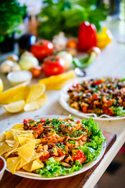 Kebabs - grilled meat, chips and vegetables on wooden background