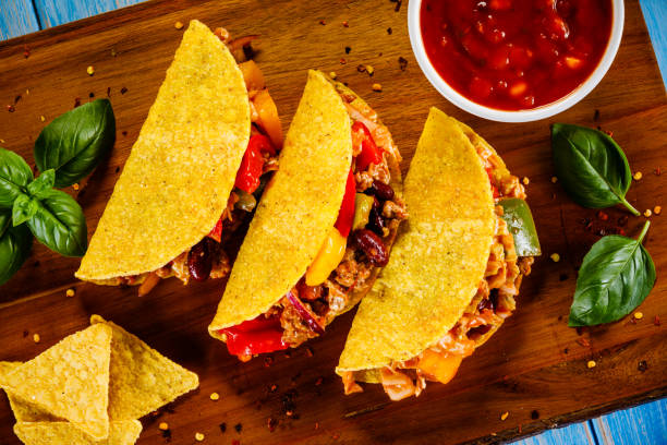 istock Tacos on cutting board on wooden table 1070955022