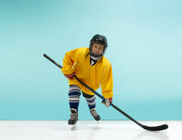 istock A hockey player with equipment over a blue background 1070955326