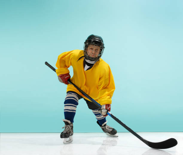 istock A hockey player with equipment over a blue background 1070955328