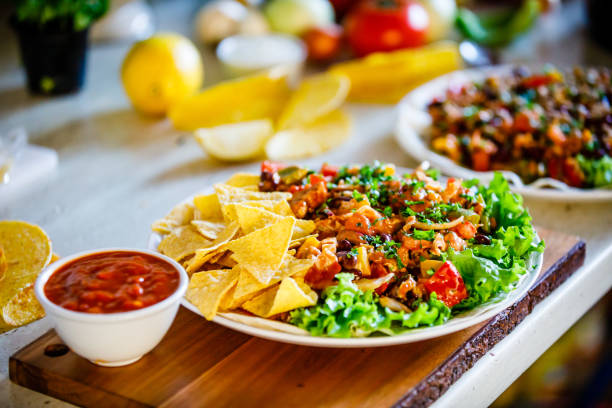 istock Kebabs - grilled meat, chips and vegetables on wooden background 1070955360