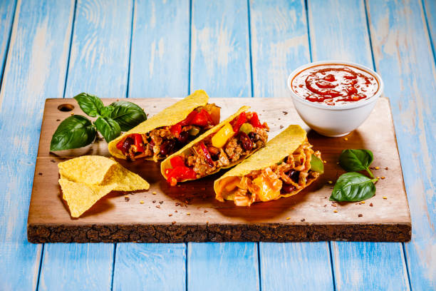istock Tacos on cutting board on wooden table 1070955446