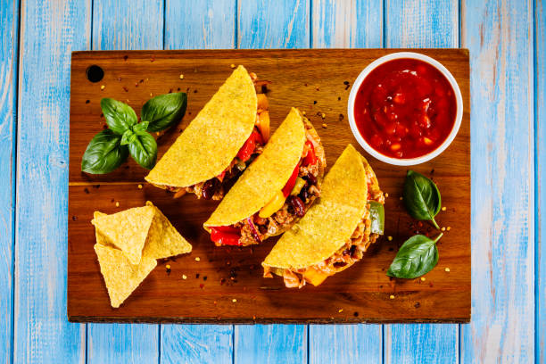 istock Tacos on cutting board on wooden table 1070955812