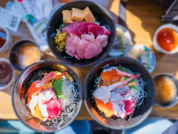 Fresh seafood rice bowl (Kaisen-don) - Japanese Rice with sashimi of tuna, Maguro, Otoro, salmon, squid and ikura