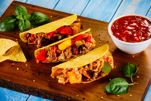 istock Tacos on cutting board on wooden table 1070956180